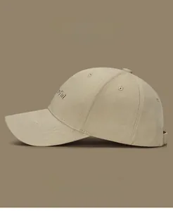 Close-up of golden letter embroidery on khaki twill cotton baseball cap side