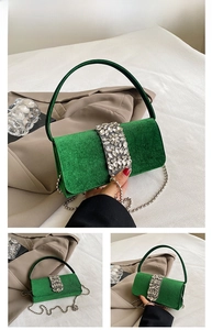 Detail of green velvet clutch bag with luxury rhinestones and beaded silver chain
