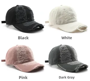 Detailed close-up showing distressed vintage baseball caps in black, white, pink, and grey