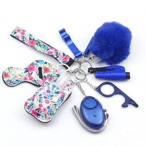 Macro view of blue floral neoprene keychain set with personal alarm and lipstick holder