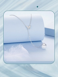 Detail of S925 silver necklace featuring a hollow butterfly pendant and white pearl