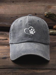 Close-up of heart and paw embroidery on a gray washed cotton baseball cap texture