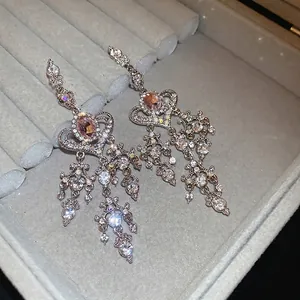 Elegant silver heart tassel earrings with sparkling pink gemstones and crystals