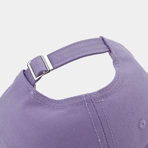 Detail of purple cotton baseball cap with adjustable silver metal buckle and neat stitching