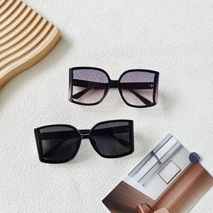 Chic oversized square sunglasses with black and purple gradient lenses on white background