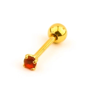 Macro shot of gold-plated titanium steel piercing stud with red round zircon and ball back