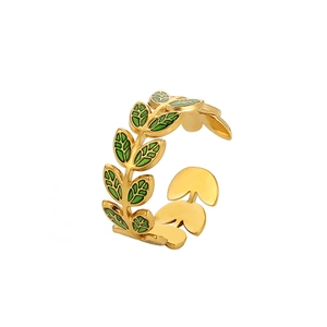 Detailed view of leaf-shaped green enamel on a 18k gold-plated stainless steel open ring