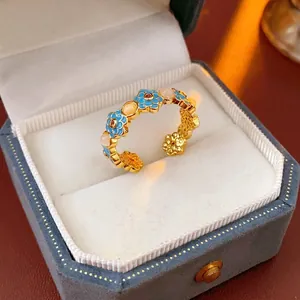 Vintage 18k gold plated open ring with blue enamel flowers and white beads in a box
