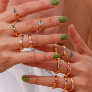 Detail of 18K gold plated rings featuring colorful rectangular zircon birthstones on hand