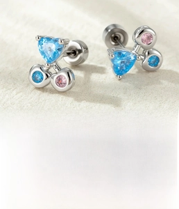 Detailed view of cherry-shaped cartilage stud with blue heart zircon and titanium steel post