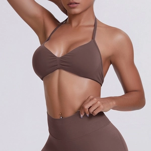 Detail of seamless brown sports bra with halter neck and matching high waist leggings