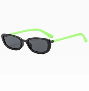 Detail of kids black oval sunglasses with neon green temples on a clean white background