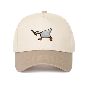 Detail of high-density goose with knife embroidery on a beige cotton baseball cap