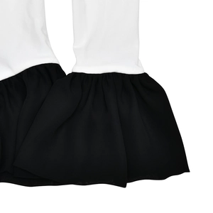 Detail of white fabric sleeve with black ruffled hem stitching on a slim fit bodysuit