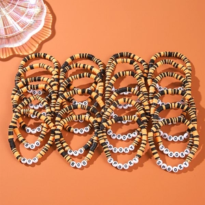 Halloween beaded bracelet set with black and orange clay beads and spooky lettering
