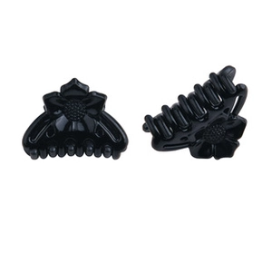 Detail view of mini black butterfly hair claws with embossed floral pattern for women