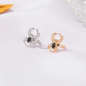Gothic punk spider ear cuff in gold and silver finish with black gemstone detailing