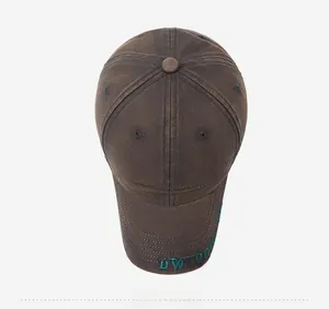 Detail view of vintage brown baseball cap with Woodwind embroidery and cotton texture