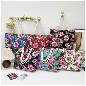 Group shot of colorful tropical floral canvas tote bags with nautical rope handles