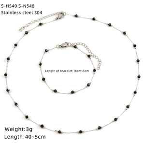 Detail view of 304 stainless steel necklace and bracelet set with black beads and charms