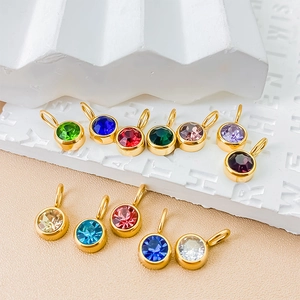 Macro view of colorful 8mm zircon pendants with gold-plated settings for DIY jewelry
