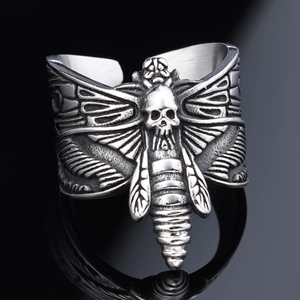 Detail macro view of gothic skeleton moth ring with antique silver finish relief
