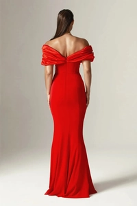 Detail of elegant red off-shoulder evening gown with fishtail hem and ruched back