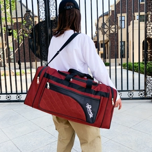 Deep red quilted sports travel bag with black straps and large capacity for fitness and travel