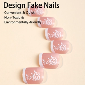 French rose press-on toenails in nude pink with white floral designs and glossy finish