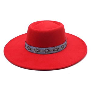 Close-up of red wool felt fedora featuring an ethnic jacquard ribbon decoration