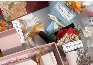 Close-up of assorted gift boxes with soap flowers and colorful dried flower bouquets