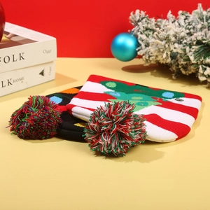 Detail of LED knitted Christmas beanies with colorful pom-poms and glowing festive patterns