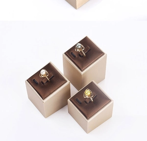 Three pearl rings in gold finish displayed on square premium jewelry boxes