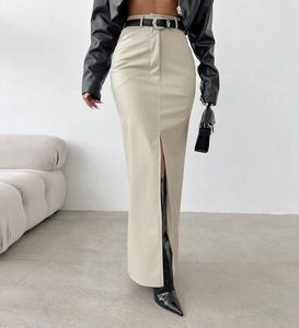 Close-up of beige high-waisted PU leather skirt featuring a stylish front slit detail