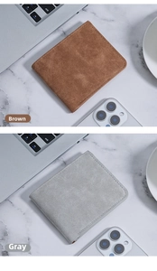 Slim bifold men wallets in brown and grey matte leather on a marble desk setting