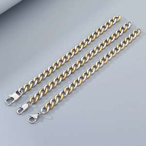Detail of three-tone gold and silver Cuban link bracelets with secure lobster clasp