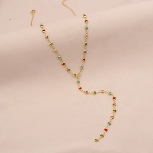 Close-up of gold-tone Y-necklace featuring colorful heart-shaped crystal pendants