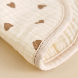 U-shaped six-layer muslin cotton baby bib with brown heart print on beige fabric