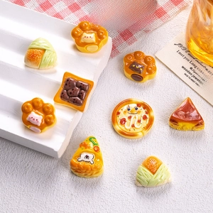 Detailed macro view of assorted miniature resin desserts on a white display stand