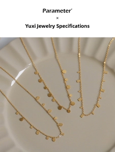 Detailed view of four 18K gold-plated teardrop necklaces on a white ceramic wave plate
