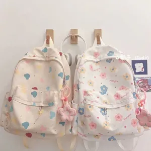 Canvas backpack with cute floral and polka dot prints plus flower charms for students