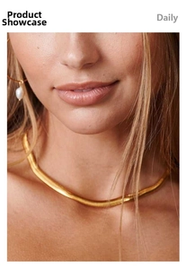 Close-up of 18K gold-plated snake bone necklace and elegant white pearl pendant earrings