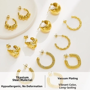 Macro detail of French vintage 18K gold plated twisted hoop earrings in titanium steel