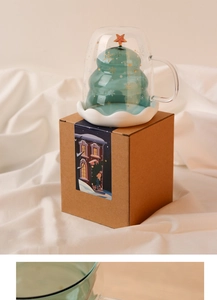 Detail view of a double-layered Christmas tree glass cup with festive gift packaging box