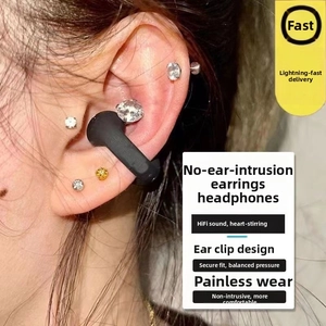 Close-up of black C-clip bone conduction earbuds showing ergonomic ear-clip fit