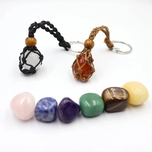 Detail of woven mesh keychains featuring polished colorful natural chakra energy stones