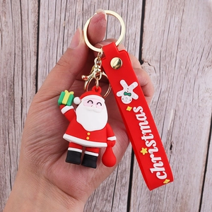Detail of Santa Claus PVC keychain with red wrist strap and gold metal hardware