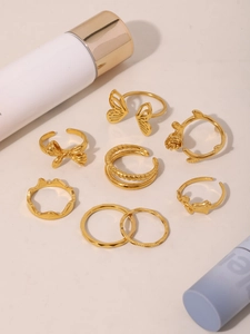 Detailed set of 7 gold-plated rings featuring butterfly and rose flower designs