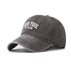 Detail view of white NEW YORK 1625 3D embroidery on washed dark grey cotton baseball cap