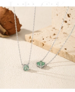Close-up of S925 silver necklace with round paraiba stone in a four-prong setting